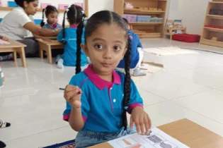Educator observing children in a Montessori classroom